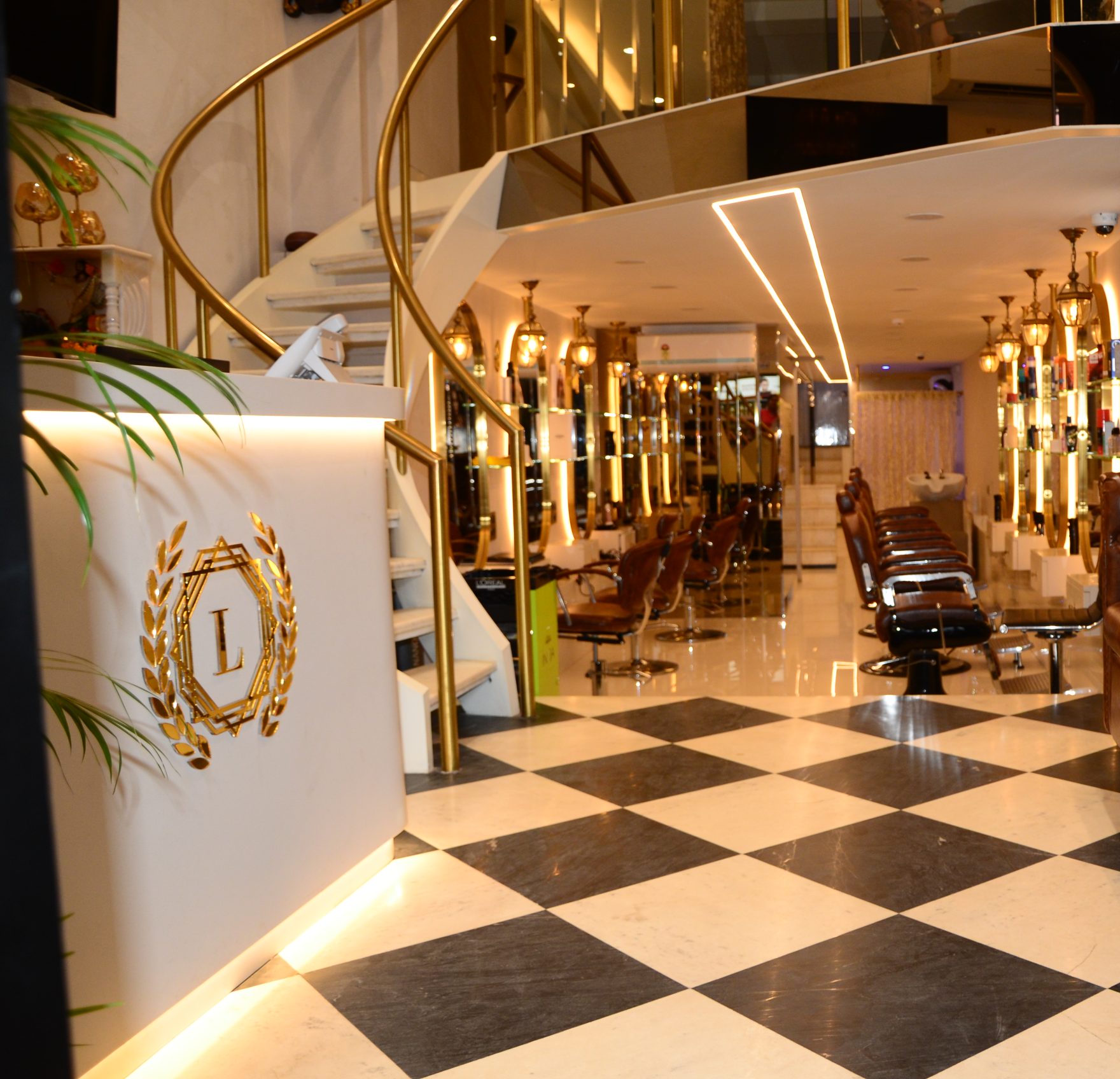 dark moody salon interior with warm ambient lighting and luxurious seating